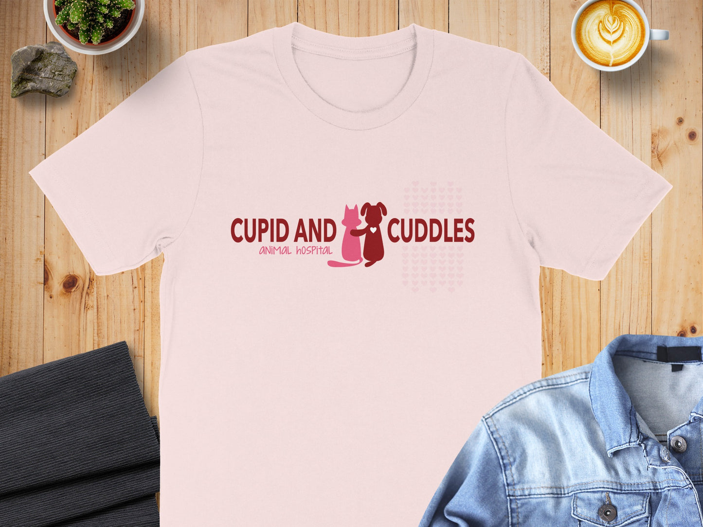 Pink t-shirt with "CUPID AND CUDDLES ANIMAL HOSPITAL" text and heart graphics.