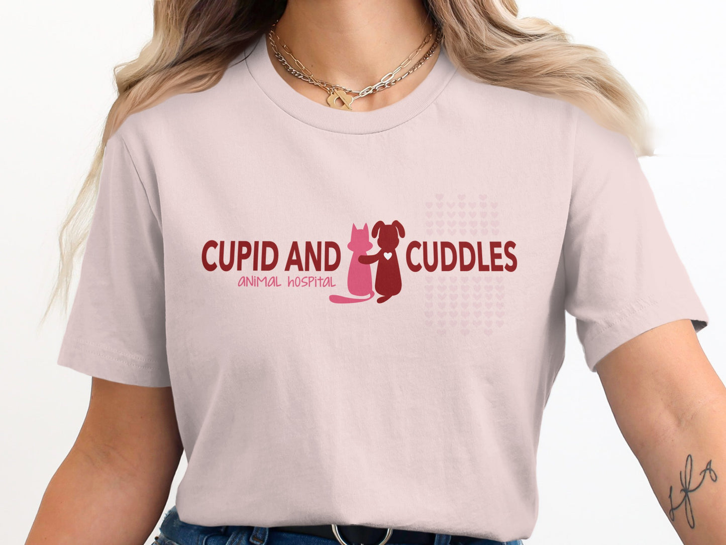 Pink t-shirt with "CUPID AND CUDDLES ANIMAL HOSPITAL" text and animal icons.