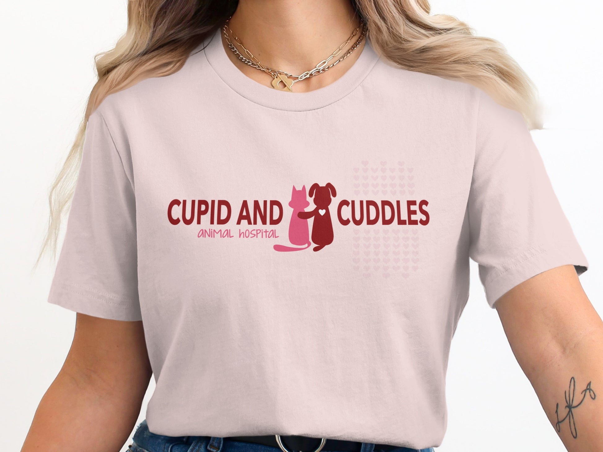 Pink t-shirt with "CUPID AND CUDDLES ANIMAL HOSPITAL" text and animal icons.