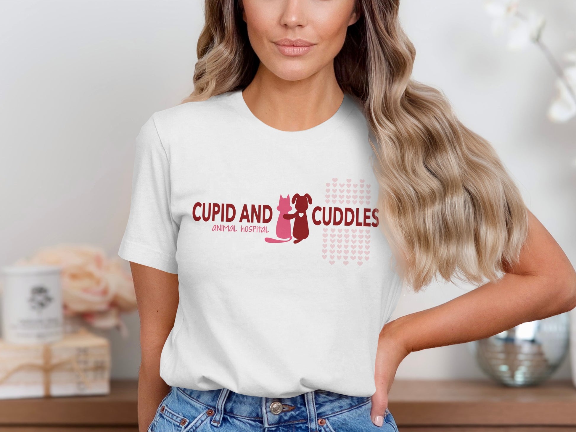 White t-shirt with "CUPID AND CUDDLES ANIMAL HOSPITAL" and heart graphics.